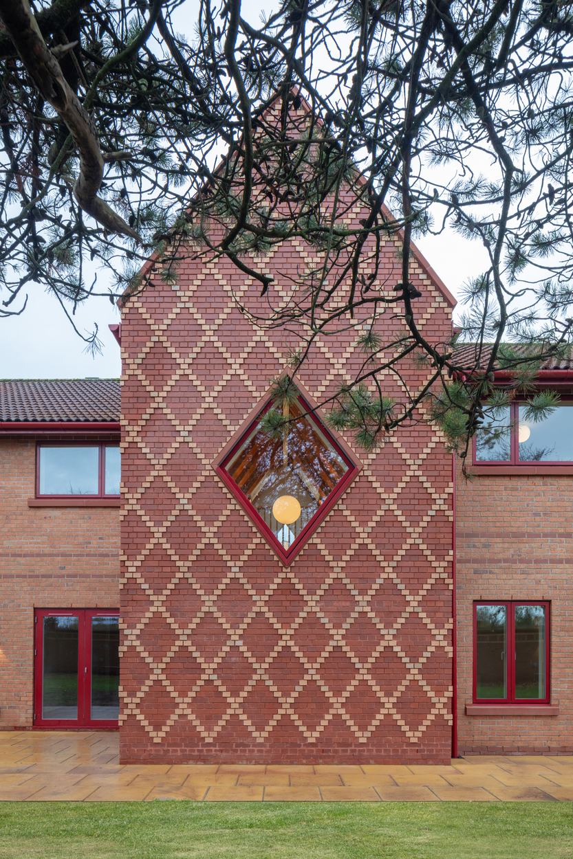 Criss-cross brickwork facade with diamond window
